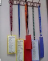  badges and lanyard hanging on wall